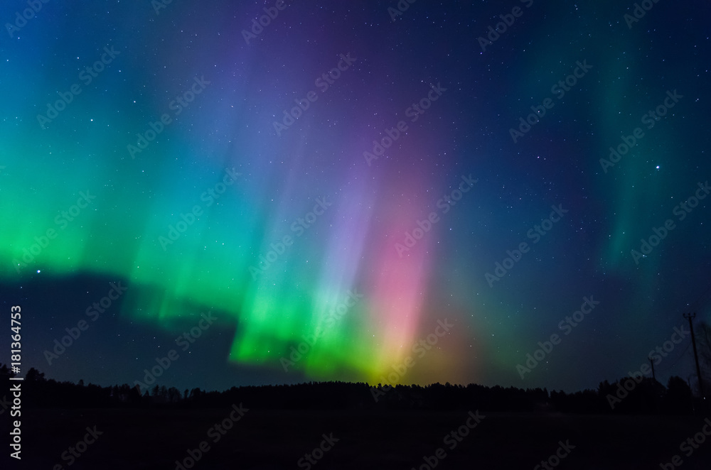 Very colorful auroras over the sky. Green, red and purple.