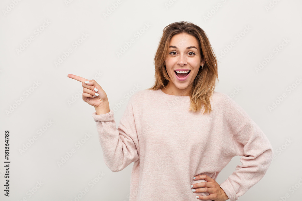 Excited woman pointing on side