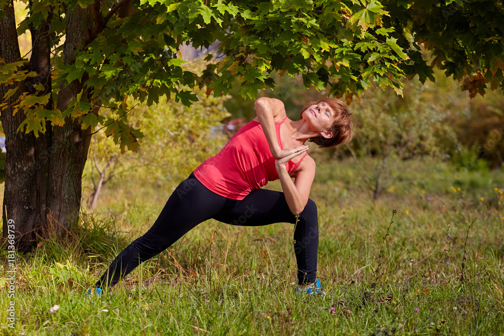 Yoga in the open air. Happy woman doing yoga exercises, meditate in the park. Yoga meditation in nature.
Yoga in the open air. Happy woman doing yoga exercises, meditate in the park. Yoga meditation in nature.