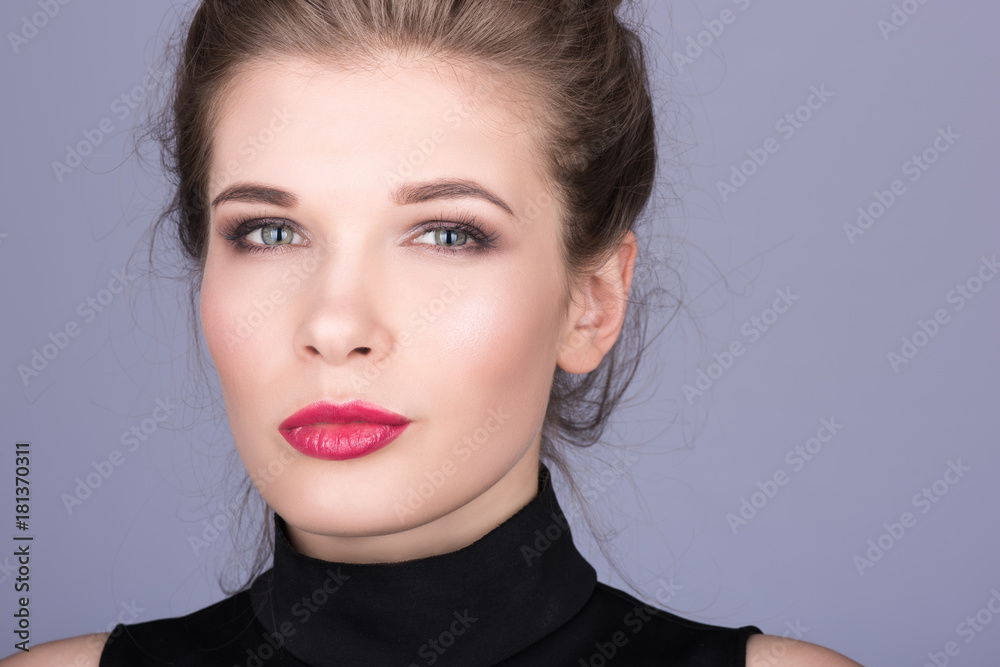 Closeup portrait of a beautiful young woman with light makeup and red lipstick Closeup portrait of a beautiful young woman with light makeup and red lipstick