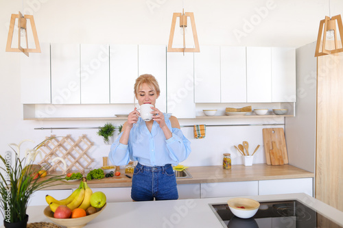 Adorable girl happy with beginning of new day and prepares tomor photo