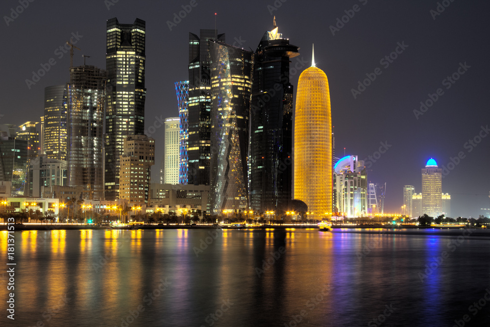 Doha, Qatar skyline at night with light reflection in the Arabic gulf