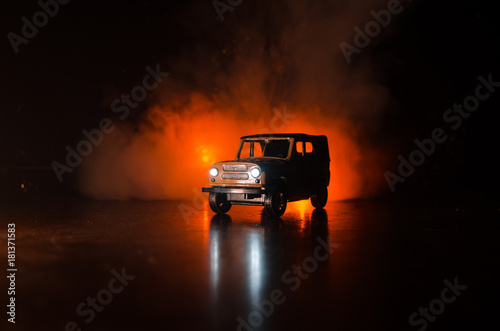 War Concept. Military silhouettes fighting scene on war fog sky background  World War Soldiers Silhouettes Below Cloudy Skyline At night. Attack scene. Armored vehicles.