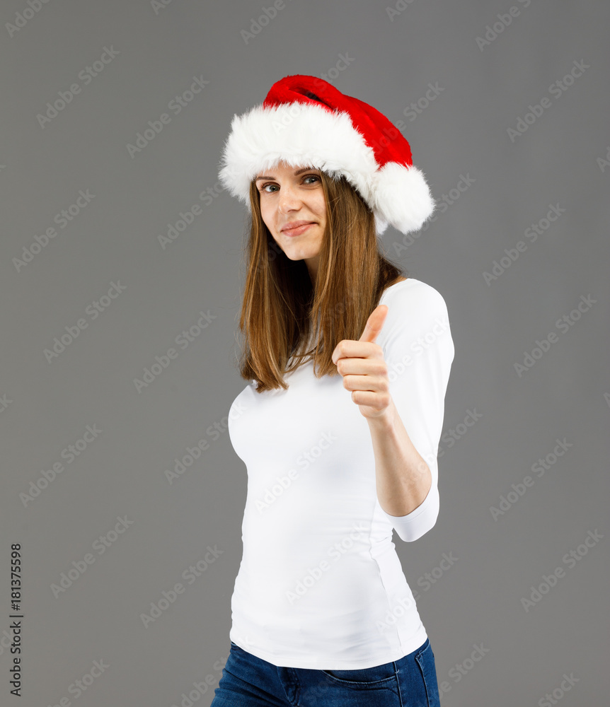 Beautiful woman in Santa Claus clothes showing OK sign Beautiful woman in Santa Claus clothes showing OK sign