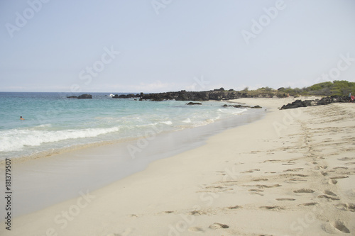 Footsteps along a Hawaiian white sand beach