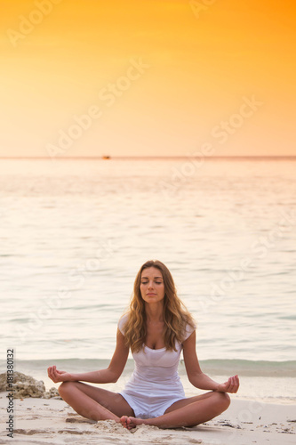 Woman practicing yoga on beach © yellowj