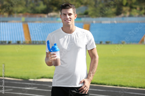Man holding bottle with pro...
