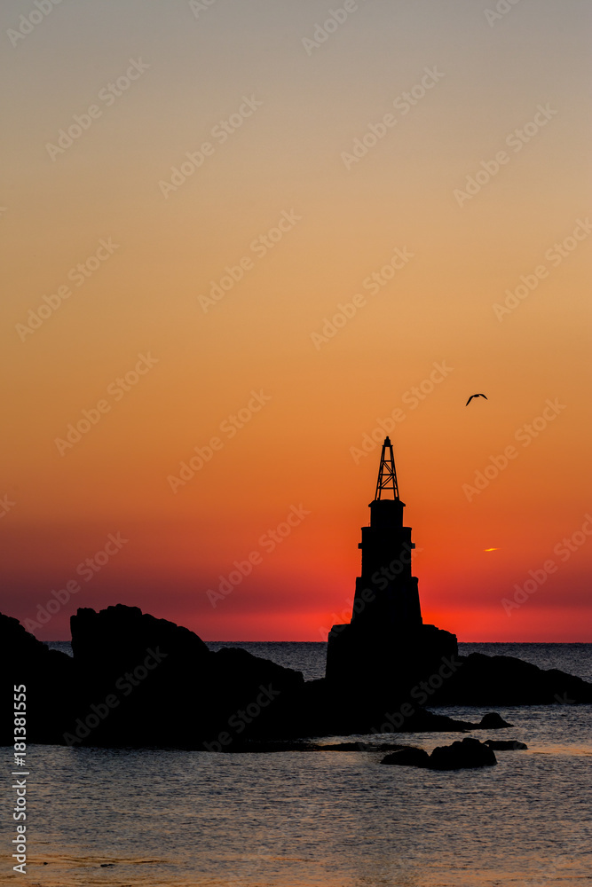 Ahtopol lighthouse silhouette at sunrise in the golden hour