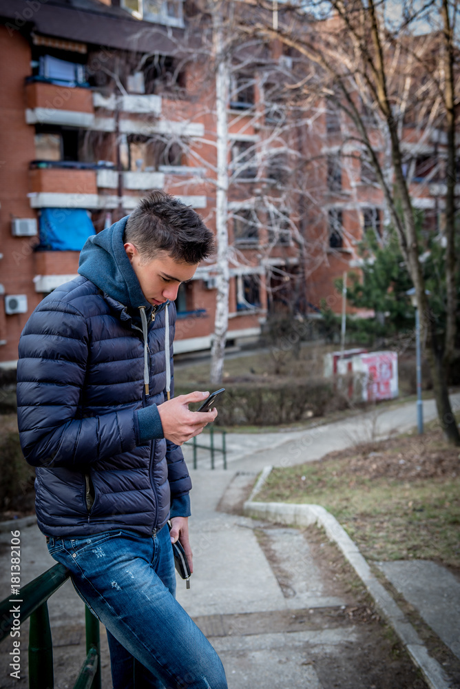 Handsome young man using mobile phone, outdoor