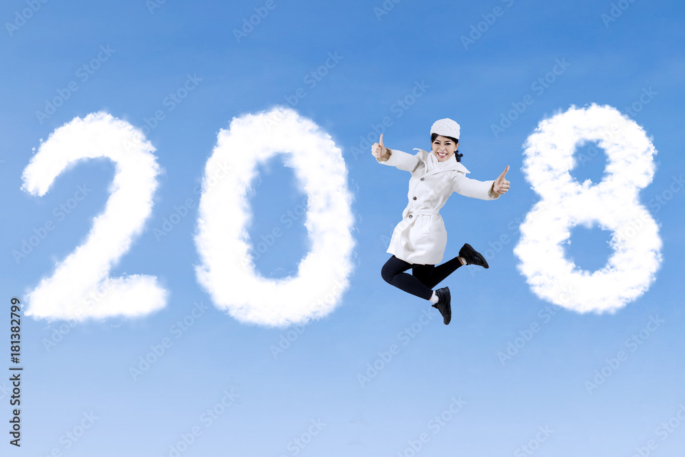 Young woman with thumbs up and numbers 2018 Young woman with thumbs up and numbers 2018