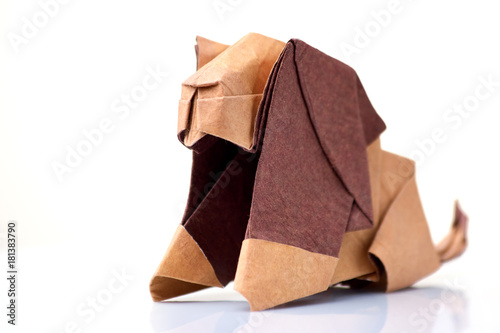 Lion origami miniature on white. Cute sculpture of animal, made of colored paper. Japanese art of folding paper.