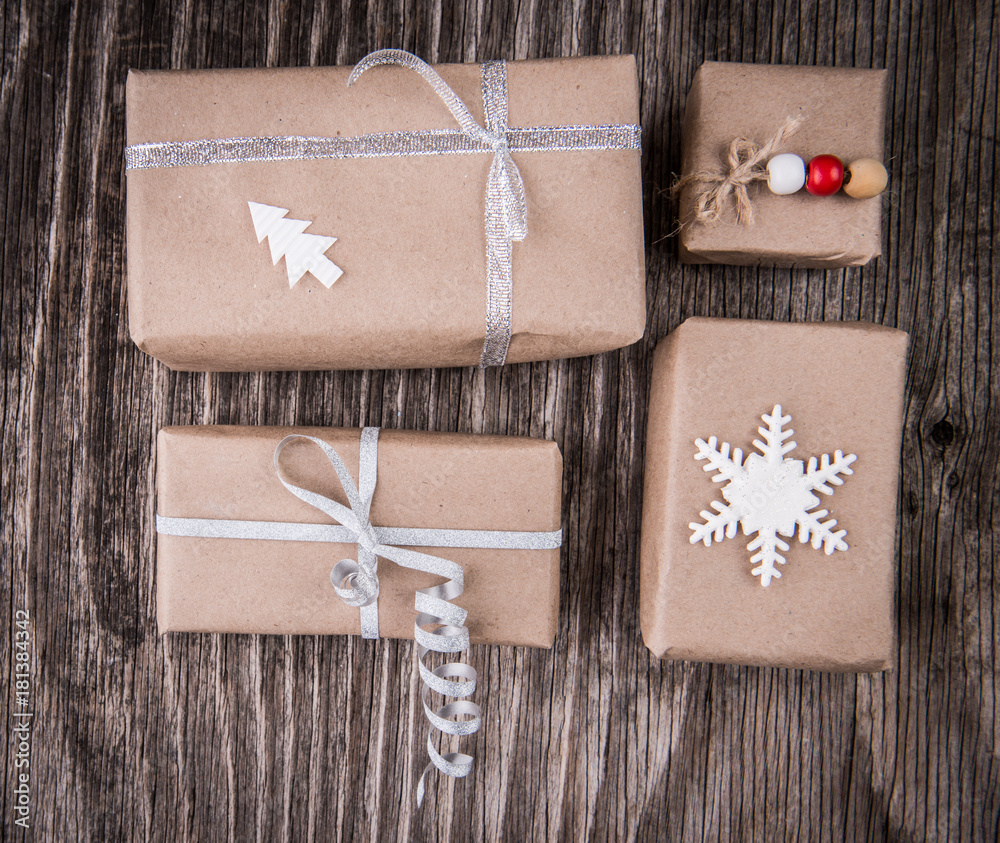Gift boxes package decorated for Christmas or New Year on rustic wooden background Gift boxes package decorated for Christmas or New Year on rustic wooden background