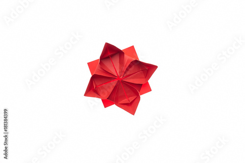 Lotus flower origami on white. Beautiful and simple model, folded red paper. Handmade ornaments, DIY, children's art.
