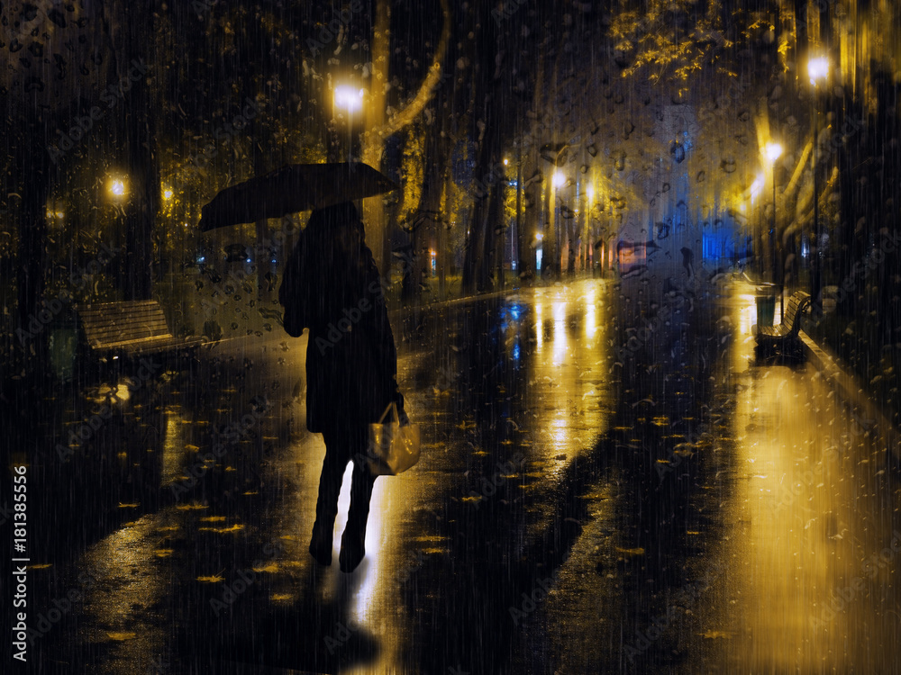 Girl at the night city lights during the rain at the evening