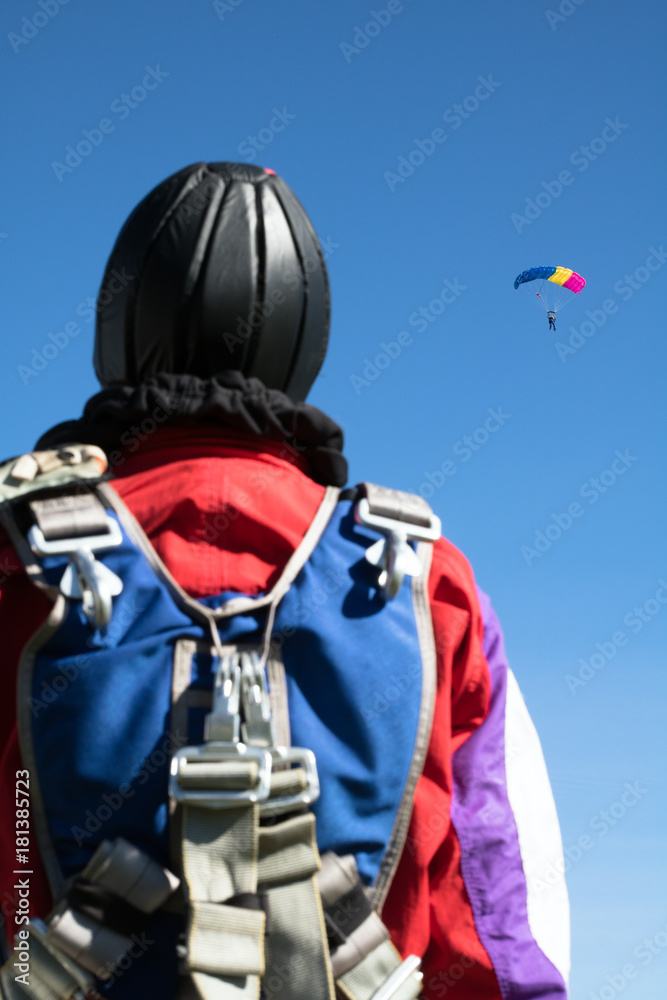 unrecognizable skydiver in unifor stands and looks at the paratroopers unrecognizable skydiver in unifor stands and looks at the paratroopers
