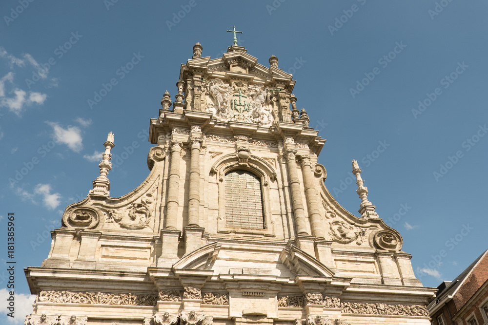 Facade of Sint-Michielskerk (Saint Michael's Church) in Leuven, Belgium, blue sky with a few clouds. Exterior of Jesuit church in Baroque style architecture.