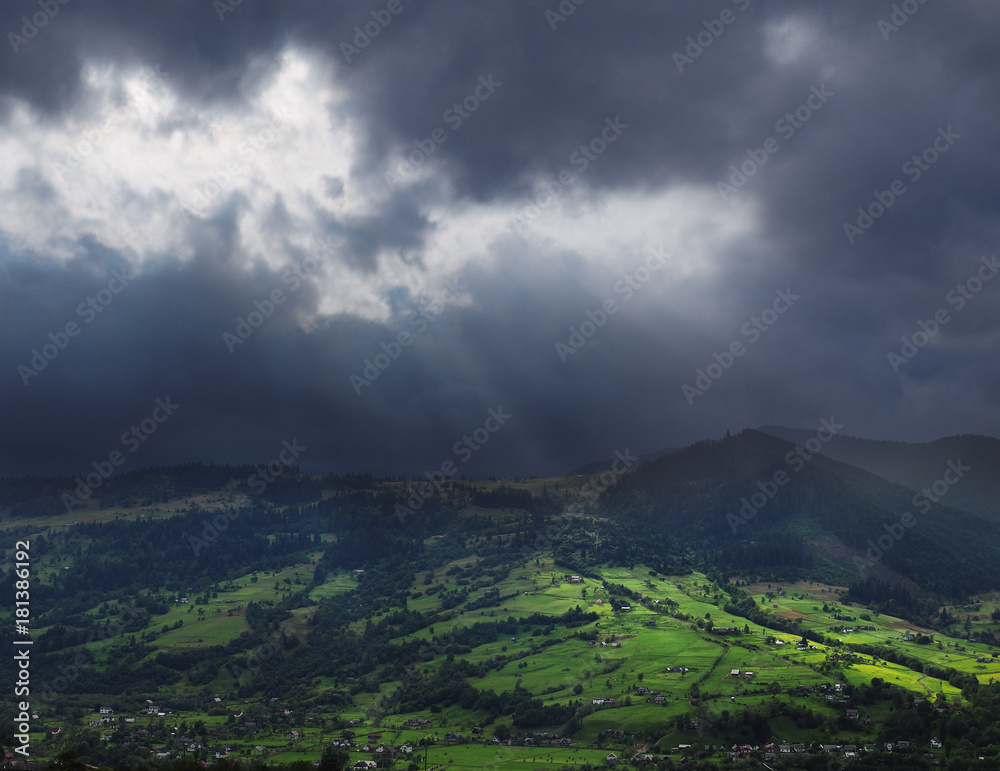 Sun rays over the villiage at the mountains