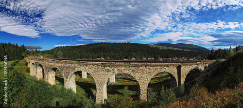 Panorama of the old stone austrian bridge through the river at the Karpatian mountains photo