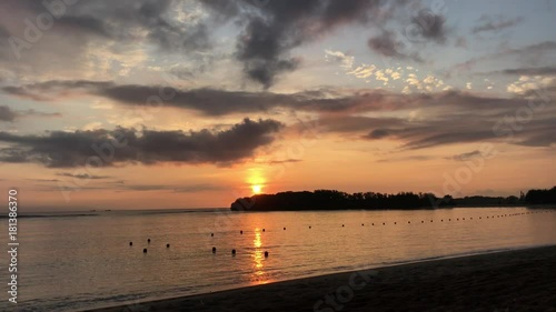 Magnificent Ocean Sunrise on a tropical island of Bali, Indonesia, Asia. Sound included. Orange sun, beach, tropical, calm. photo