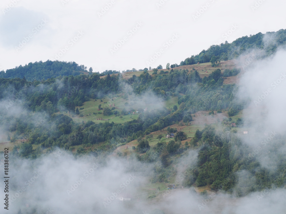 Fog at the village in the carpatian mountains