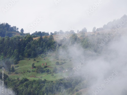 Fog at the village in the carpatian mountains