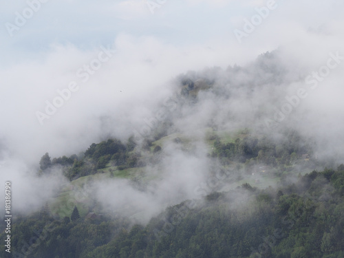 Fog at the village in the carpatian mountains