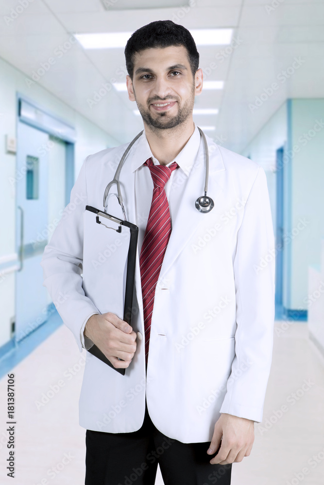 Arabian doctor with clipboard in the hospital
