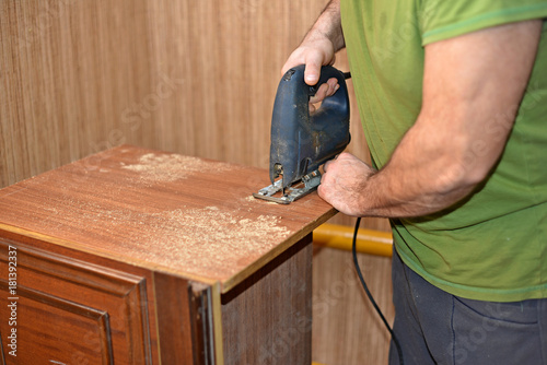 Craftsman using Jigsaw, making Furniture Concept photo