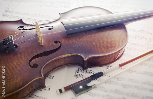 Violine mit Bogen auf Notenblättern photo