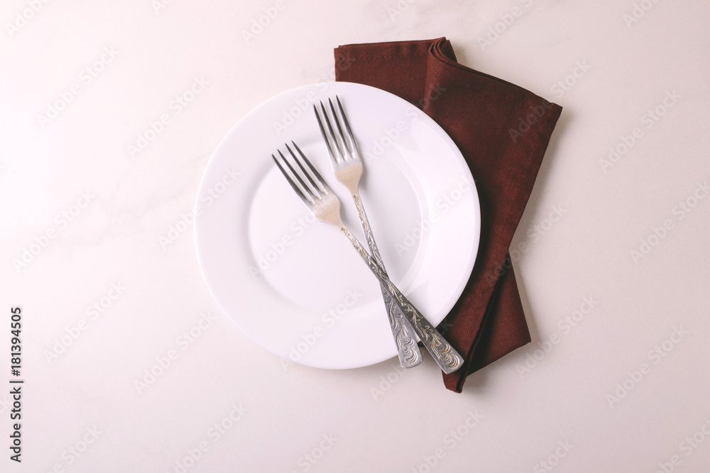 Food background. White empty plate, cutlery, napkin. Top view, copyspace. Food background. White empty plate, cutlery, napkin. Top view, copyspace.
