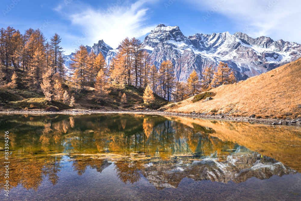 Reflection into Lago del Sangiatto in Alpe Devero in autumn, province of Verbano Cusio - Ossola, Piemonte, Italy