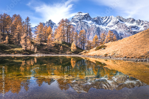 Reflection into Lago del Sangiatto in Alpe Devero in autumn, province of Verbano Cusio - Ossola, Piemonte, Italy
