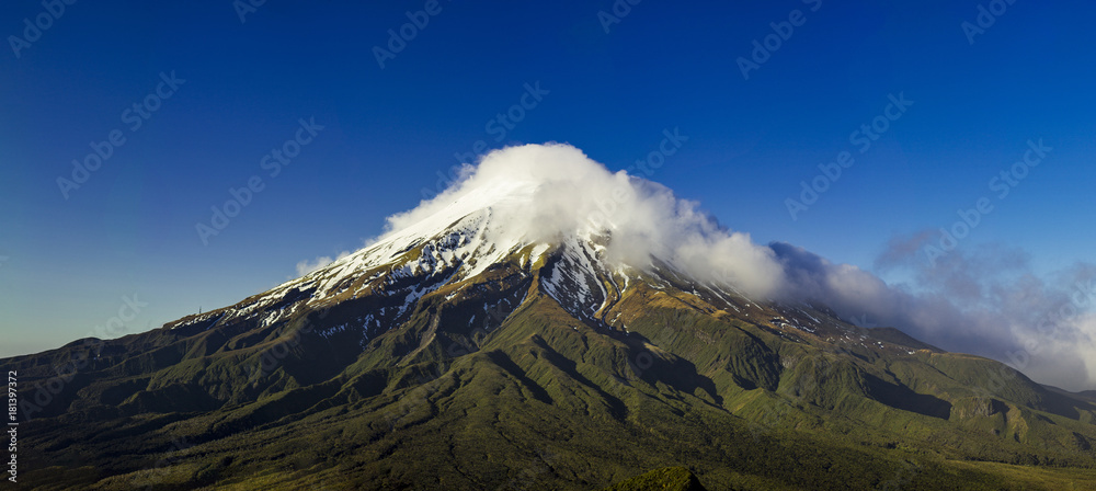 Fototapeta premium taranaki or mount egmont vulcano covered with snow during winter in new zealand near new plymouth