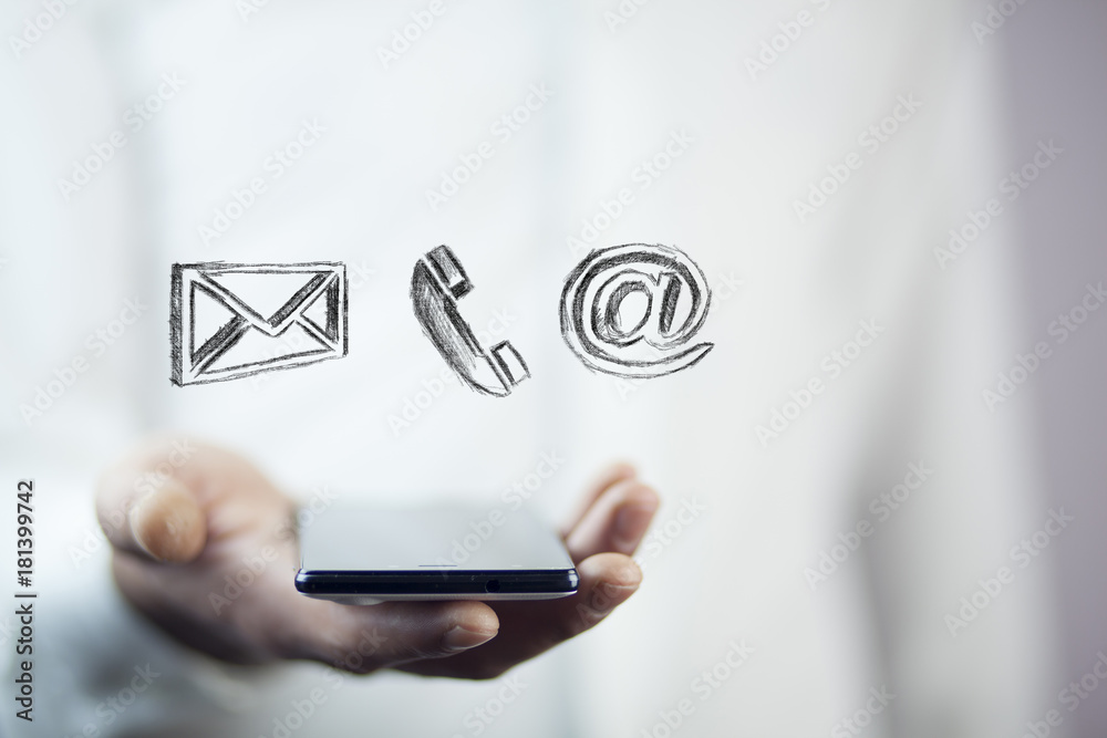 Man using a mobile phone while emitting a clouds of contact icons in a conceptual image. Man using a mobile phone while emitting a clouds of contact icons in a conceptual image.