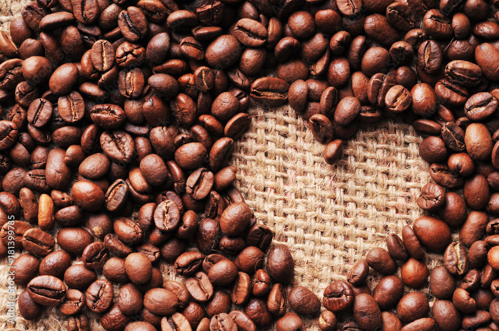 Heart shape made from coffee beans on a burlap Heart shape made from coffee beans on a burlap