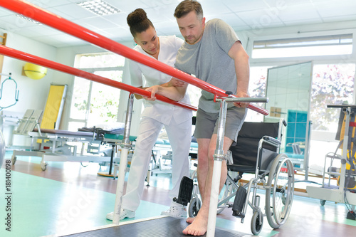 physiotherapist helping patient to walk photo