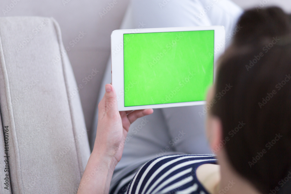 woman on sofa using tablet computer woman on sofa using tablet computer