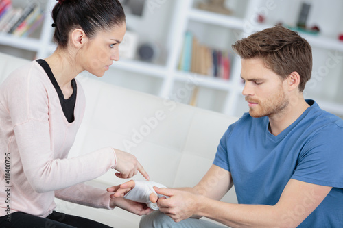 Woman questioning man about bangdaged hand