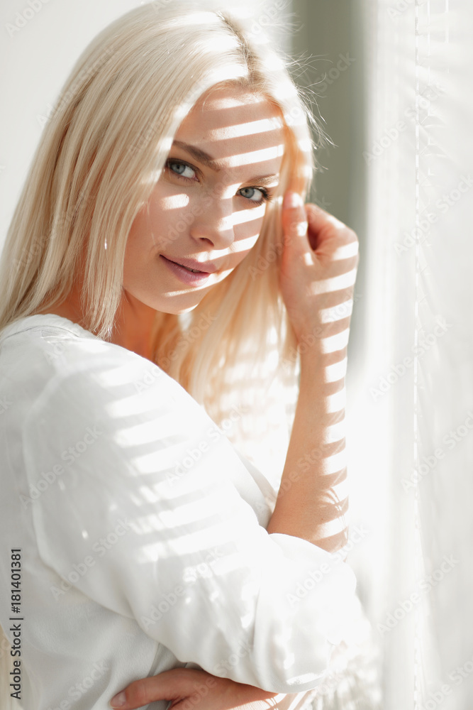 close-up of a young business woman standing near a window close-up of a young business woman standing near a window