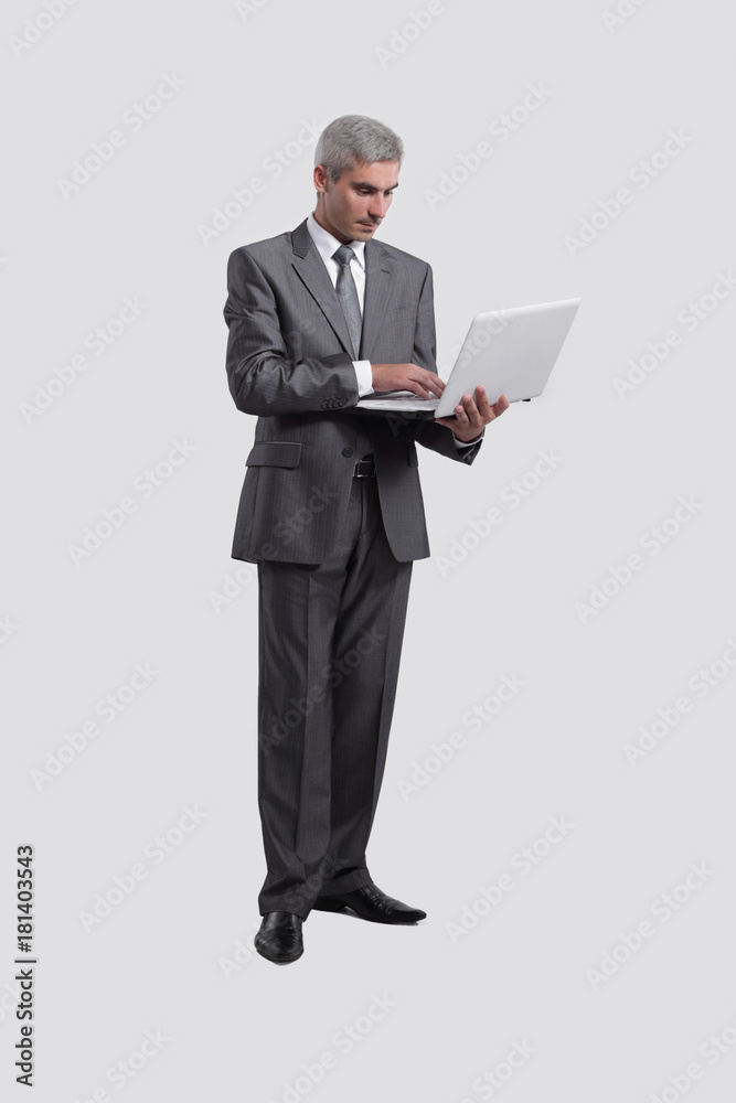 businessman standing with an open laptop businessman standing with an open laptop