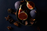 Close-up Picture of Fresh and dried Deep Blue Figs on a Dark Background.