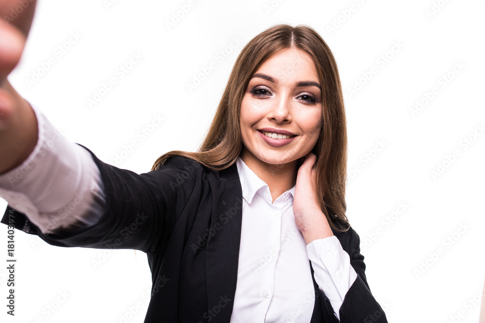 Closeup of beautiful playful business woman making selfie photo on isolated white background and looking at camera Closeup of beautiful playful business woman making selfie photo on isolated white background and looking at camera