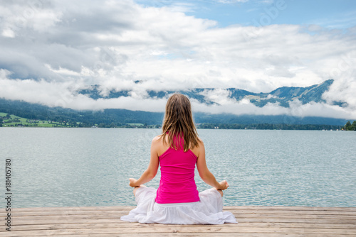 Woman meditating at the lake