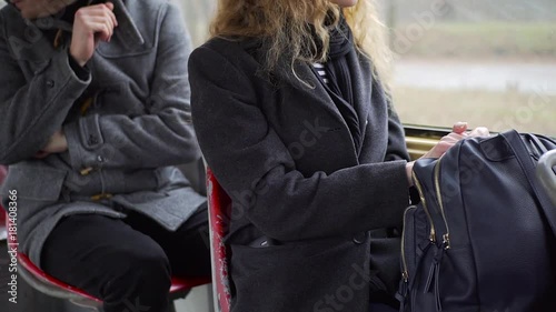 Pickpocket stealing phone from a woman's pocket in tram or bus