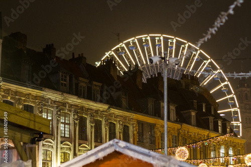 Lille, France, Christmas Market 2017 with Ferris wheel, big tree, lights and market stalls photo