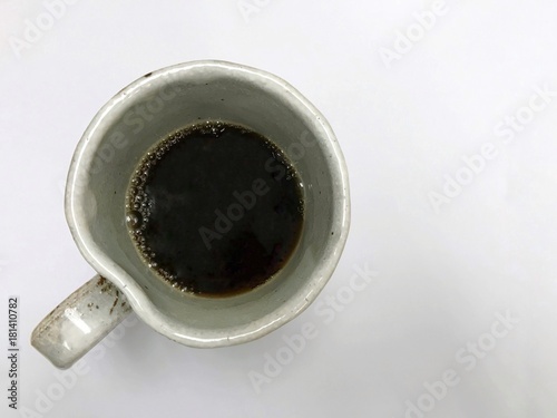 Black coffee in handmade cup on white background