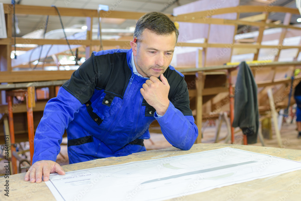 shipwright studying the design