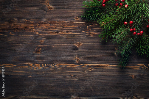 Fir branches on a wooden background
