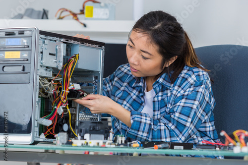 Wallpaper Mural female pc technician soldering a chip from a desktop computer Torontodigital.ca