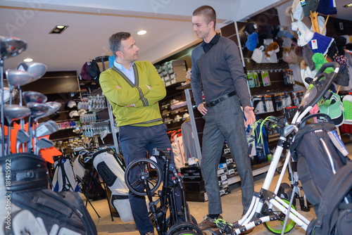 man and son in sport shop photo